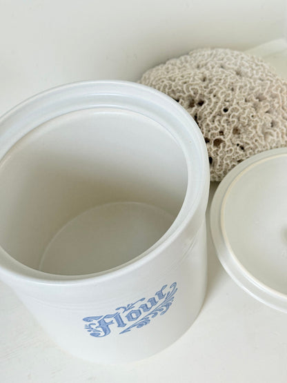 Pfaltzgraff Yorktowne stoneware flour pot with blue floral motif and lid, photographed on a white surface