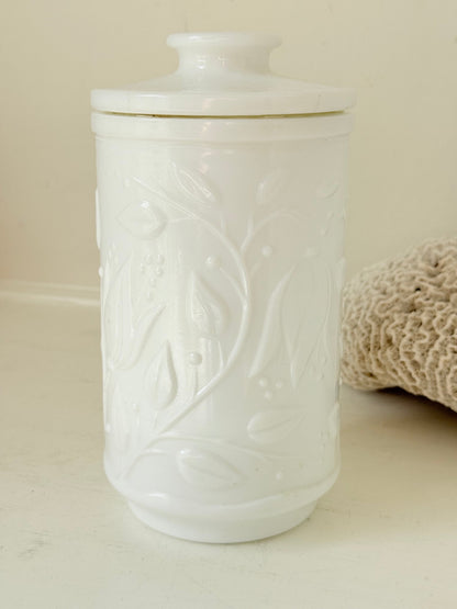 French opale glass jar with floral raised design, white vintage milk glass, shown on white background