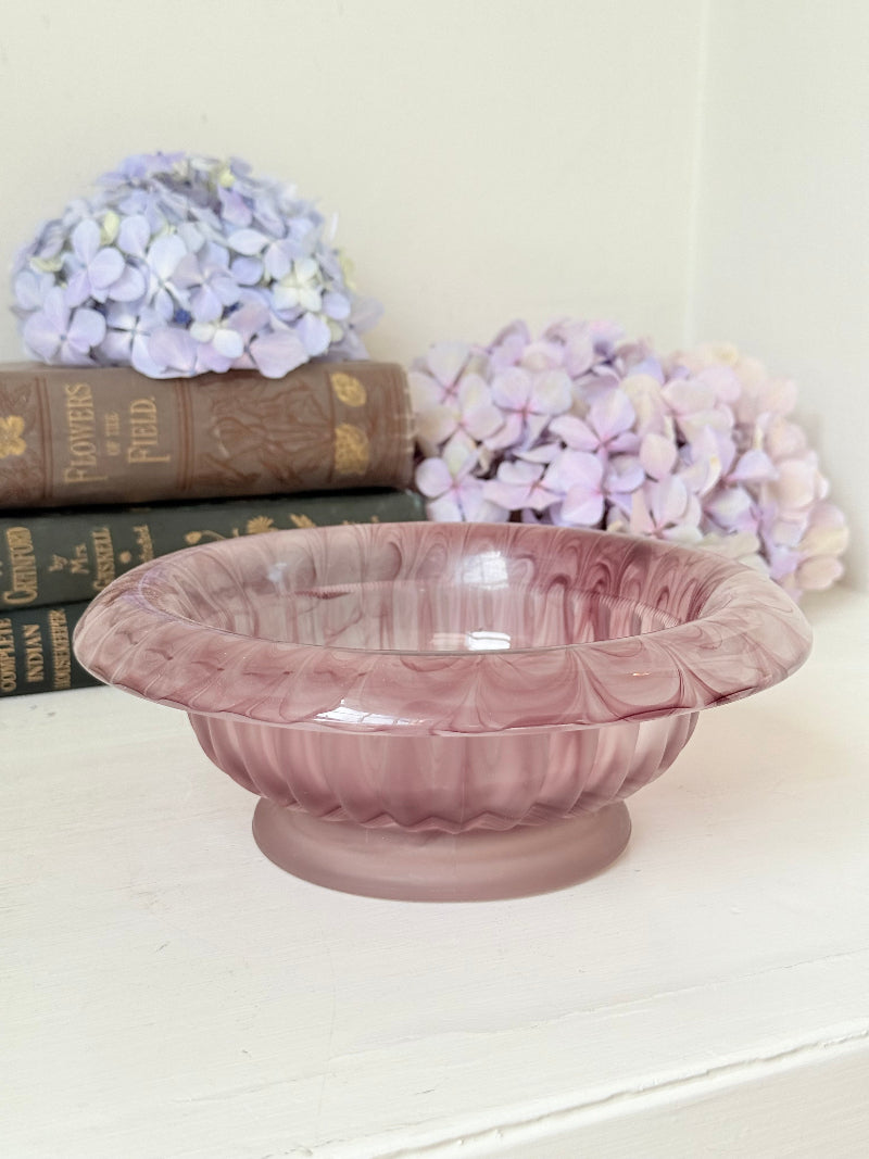 Davidson Cloud Glass bowl in amethyst with swirl pattern and footed base, styled with books and hydrangeas