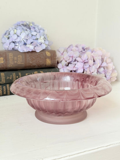 Davidson Cloud Glass bowl in amethyst with swirl pattern and footed base, styled with books and hydrangeas