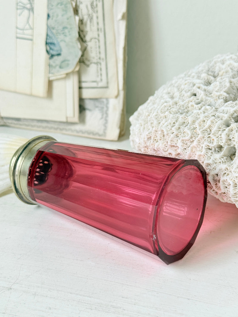 Antique cranberry glass sugar shaker with ribbed optic body, pierced metal top, star holes and deep pink glass