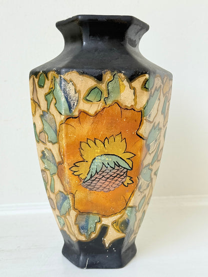 Art Deco Brentleigh Ware vase with hand painted floral design in orange, yellow, and teal on a black ground, photographed on a white surface