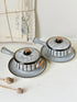 Denby Studio pair of lidded soup bowls with stands in grey and rust photographed on a white surface