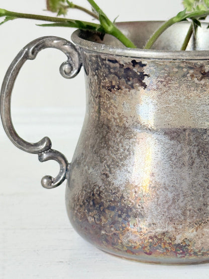 vintage silver plate beaker by arthur price with ornate handle and patina, photographed with red flowers on a white surface