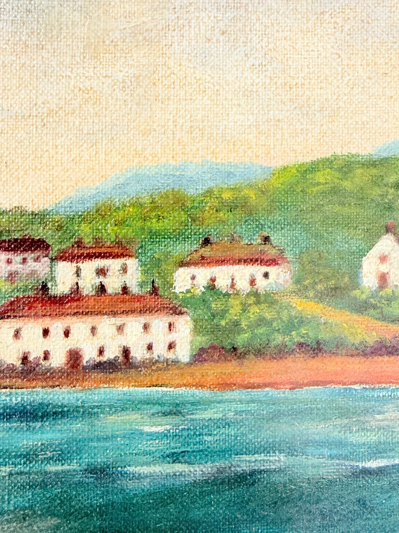 A textured painting of a coastal village scene with white buildings and red roofs along a shoreline, green hills in the background, and blue water in the foreground.