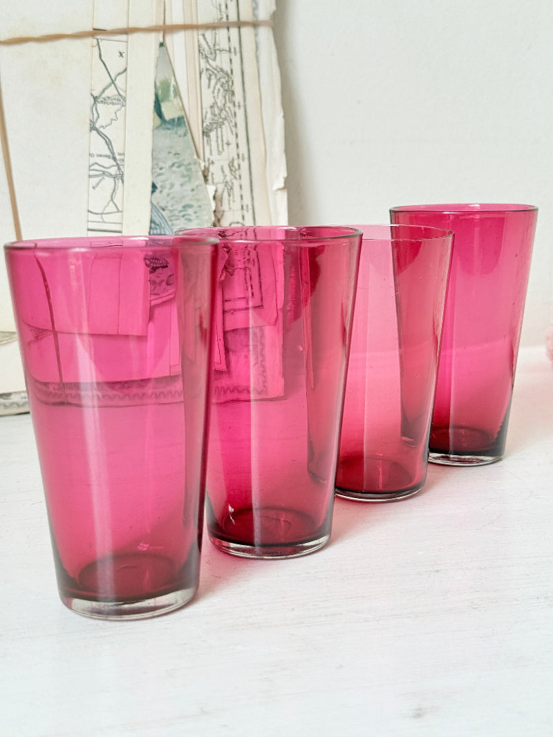 Set of 4 vintage cranberry glass tumblers in tall beaker form with deep pink colour and one slightly paler glass