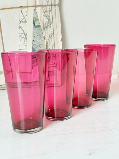 Set of 4 vintage cranberry glass tumblers in tall beaker form with deep pink colour and one slightly paler glass