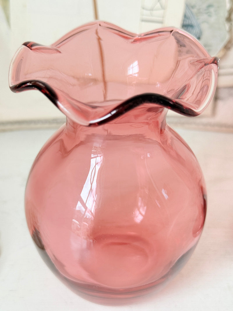 Pair of cranberry glass vases with crimped frill rims, trumpet vase and bulbous bud vase in soft pink glass