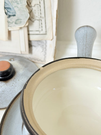 Denby Studio pair of lidded soup bowls with stands in grey and rust photographed on a white surface
