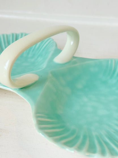 Poole Pottery Shagreen double scallop dish in sea green glaze photographed on a white surface