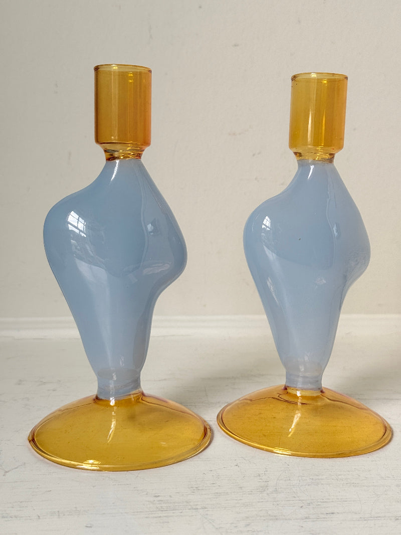 Pair of &amp;Klevering Amsterdam Flux glass candle holders in light blue and amber with pink taper candles