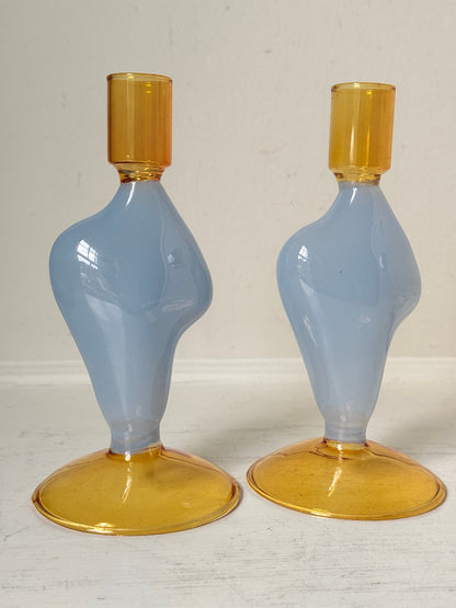 Pair of &amp;Klevering Amsterdam Flux glass candle holders in light blue and amber with pink taper candles