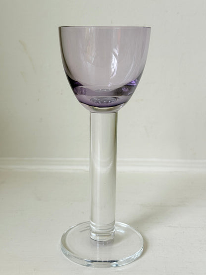 Set of 8 vintage lilac tinted liqueur glasses on a white surface