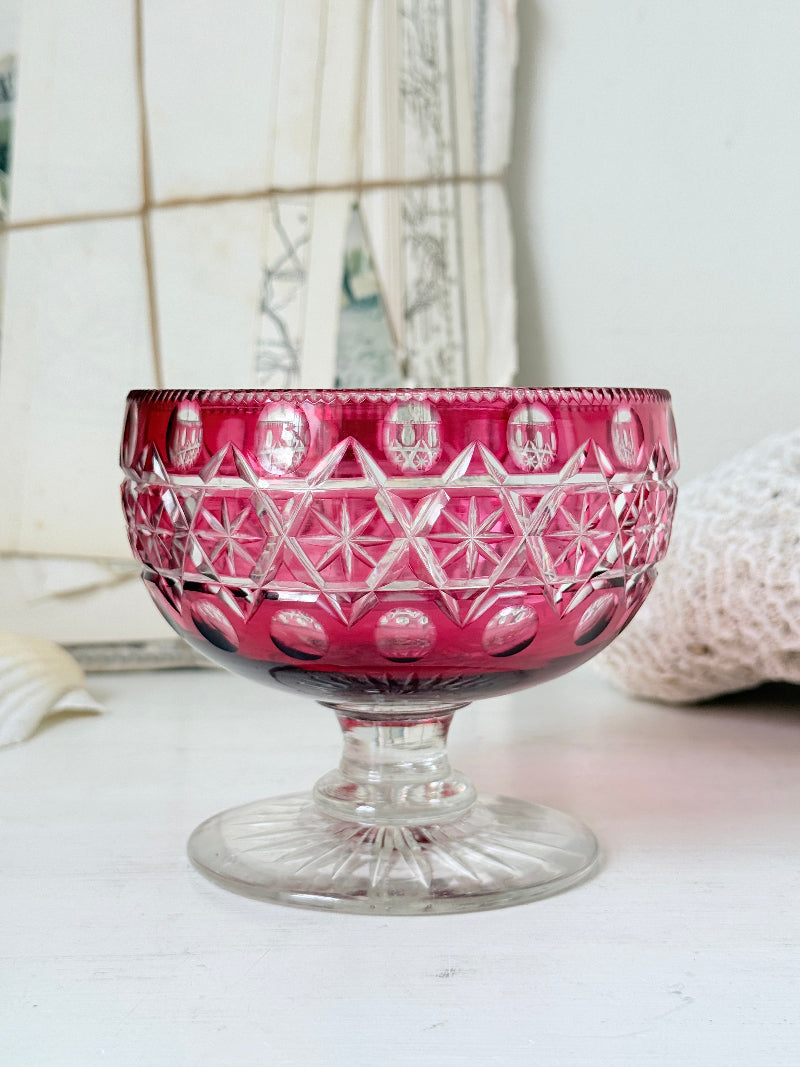 Antique cranberry cut to clear glass pedestal bowl with star and diamond pattern, clear foot and rich pink glass
