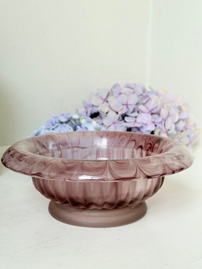 Davidson Cloud Glass bowl in amethyst with swirl pattern and footed base, styled with books and hydrangeas