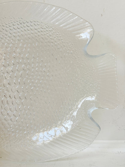 Vintage clear glass fish shaped serving dish with textured scale pattern photographed on a white surface