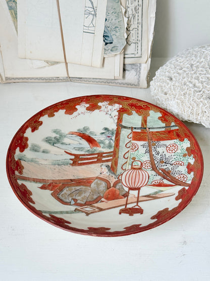 Japanese Kutani porcelain dish hand painted with a garden pavilion scene in iron red and gold