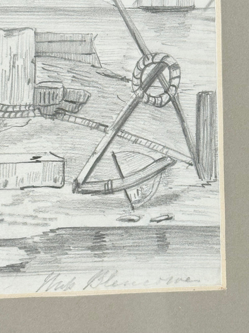 Vintage pencil drawing of rural scene with outbuildings and figures, under glass in black wooden frame, photographed on white surface.