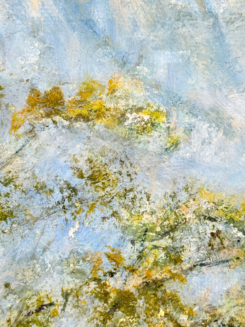 Impressionistic landscape painting featuring textured brushstrokes of light blue sky, soft white clouds, and golden-yellow foliage with hints of green.