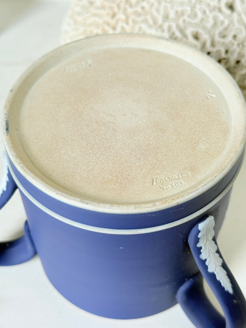 Adam’s blue jasperware loving cup with white classical relief decoration photographed on a white surface.