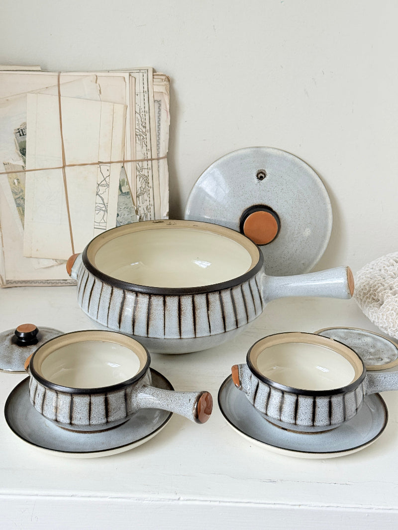 Denby Studio stoneware casserole and soup bowl set in grey and rust photographed on a white surface