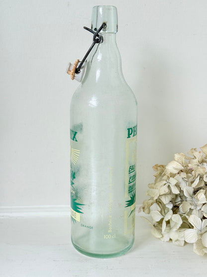 vintage french soda bottle phenix aqua green glass with ceramic swing top 31cm on white surface