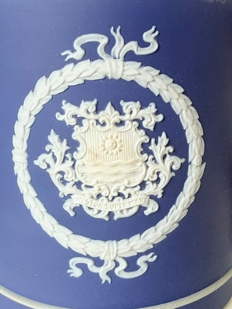 Adam’s blue jasperware loving cup with white classical relief decoration photographed on a white surface.