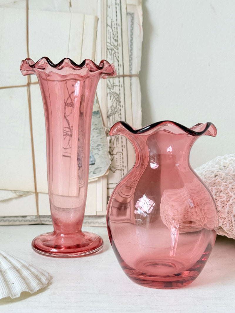 Pair of cranberry glass vases with crimped frill rims, trumpet vase and bulbous bud vase in soft pink glass
