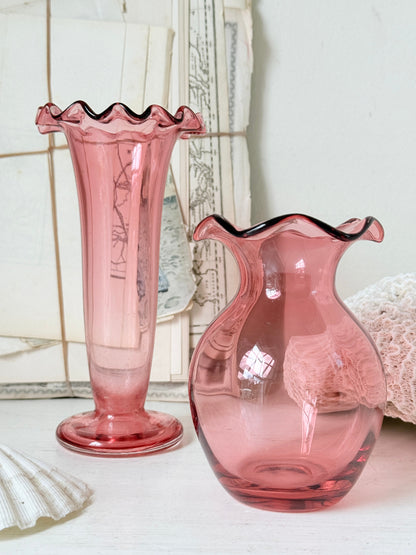 Pair of cranberry glass vases with crimped frill rims, trumpet vase and bulbous bud vase in soft pink glass