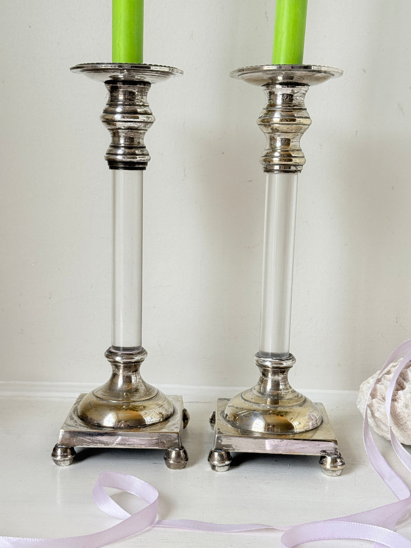 Pair of Hollywood Regency silver plate and Perspex Lucite candlesticks on bun feet with green taper candles