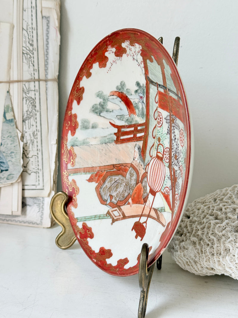 Japanese Kutani porcelain dish hand painted with a garden pavilion scene in iron red and gold