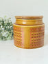 Vintage Hornsea kitchen canister in Saffron yellow with wooden lid photographed on a white surface.