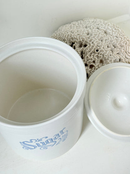 Pfaltzgraff Yorktowne stoneware sugar jar with blue floral motif and lid, photographed on a white surface