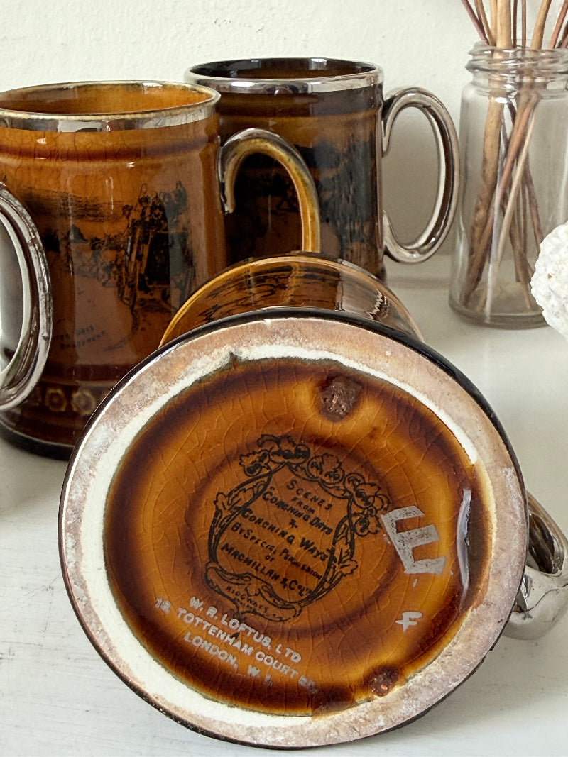 Set of 4 Ridgways stoneware tankard mugs photographed on a white surface in amber brown glaze with black Coaching Days and Coaching Ways transfer scenes