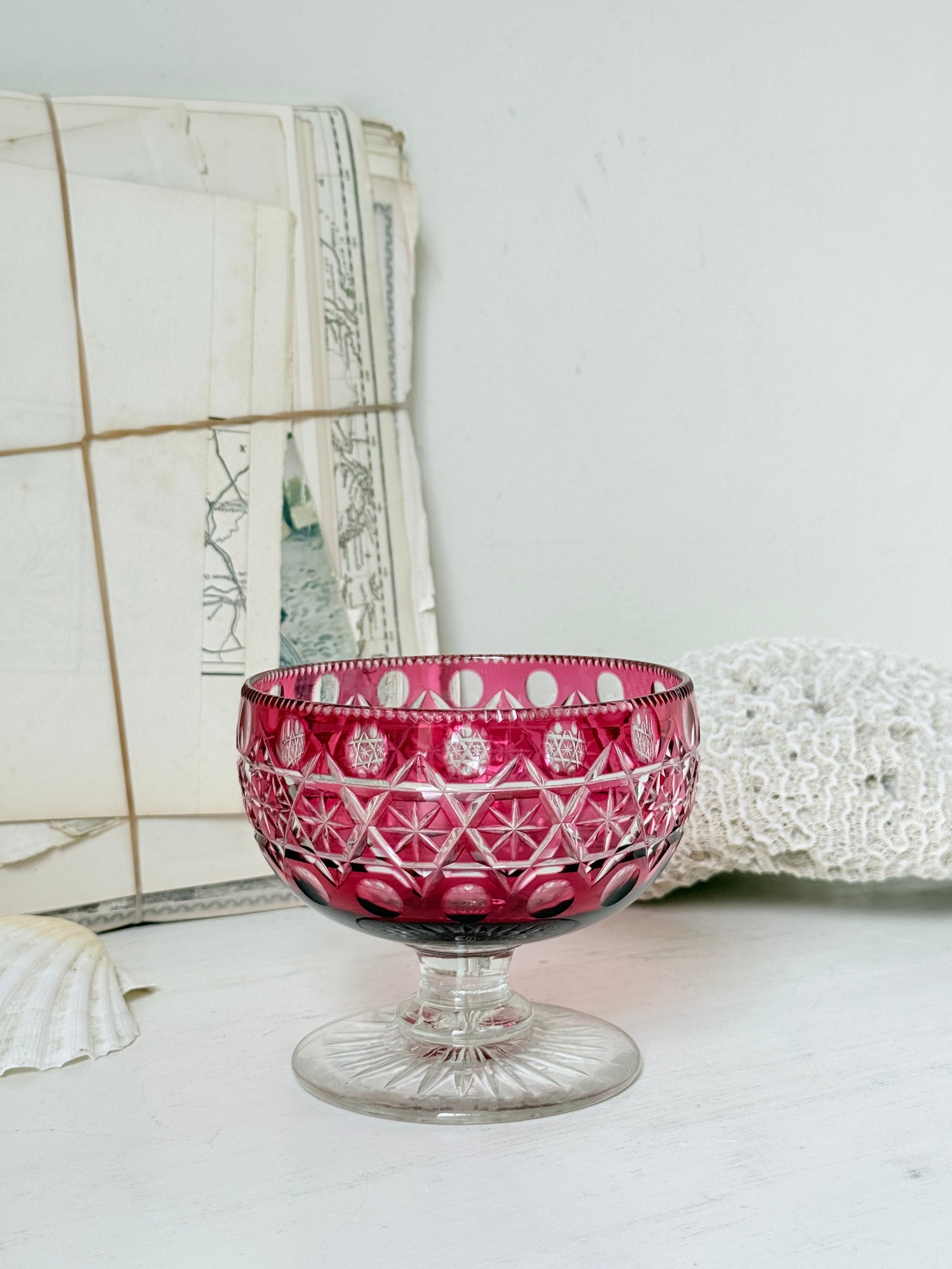 Antique cranberry cut to clear glass pedestal bowl with star and diamond pattern, clear foot and rich pink glass