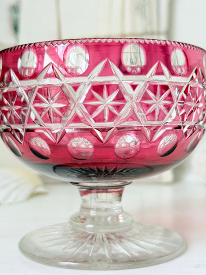 Antique cranberry cut to clear glass pedestal bowl with star and diamond pattern, clear foot and rich pink glass