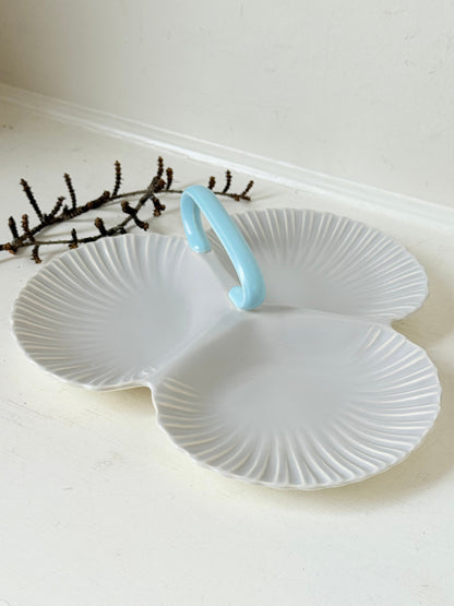 Poole Pottery triple scallop hors d’oeuvre dish in grey glaze with powder blue handle photographed on a white surface