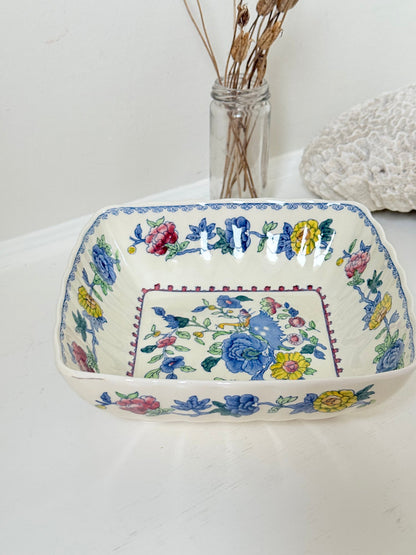 Vintage Mason’s ironstone serving dish with square form and spring floral pattern in blue, pink, yellow, and green, photographed on a white surface