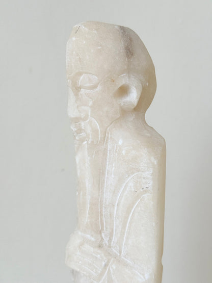vintage alabaster gentleman figure on square base with carved detail, photographed on white surface with hydrangea flowers.