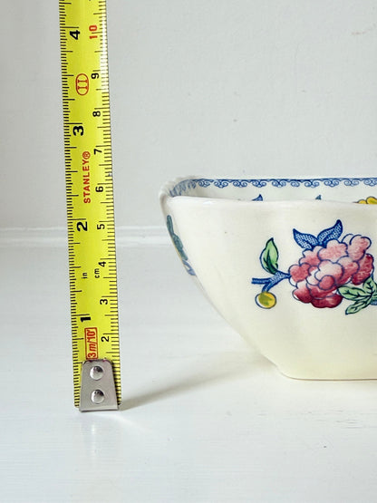 Vintage Mason’s ironstone serving dish with square form and spring floral pattern in blue, pink, yellow, and green, photographed on a white surface