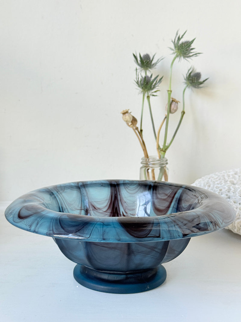 George Davidson blue cloud glass bowl with purple marbled swirls, photographed on a white surface