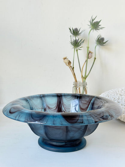 George Davidson blue cloud glass bowl with purple marbled swirls, photographed on a white surface