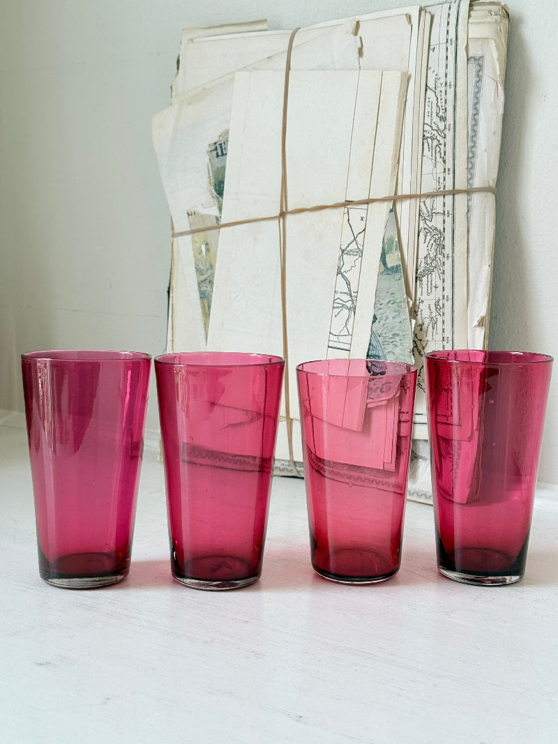 Set of 4 vintage cranberry glass tumblers in tall beaker form with deep pink colour and one slightly paler glass