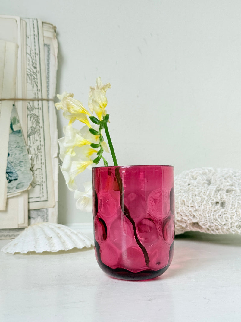 Vintage cranberry glass beaker with honeycomb optic pattern, deep pink colour and textured moulded glass for shelf styling