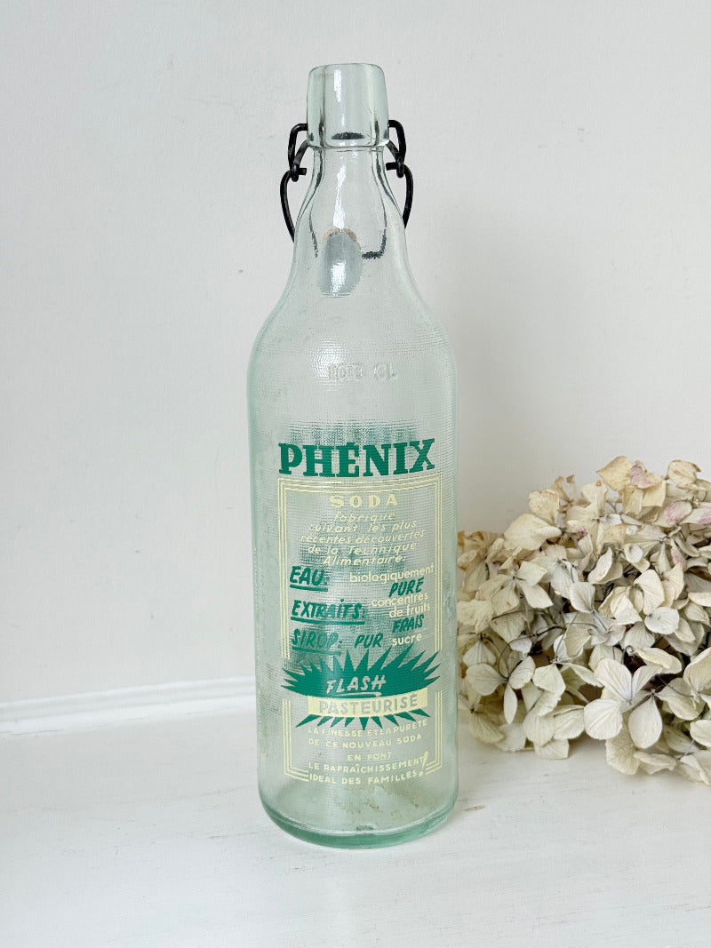 vintage french soda bottle phenix aqua green glass with ceramic swing top 31cm on white surface