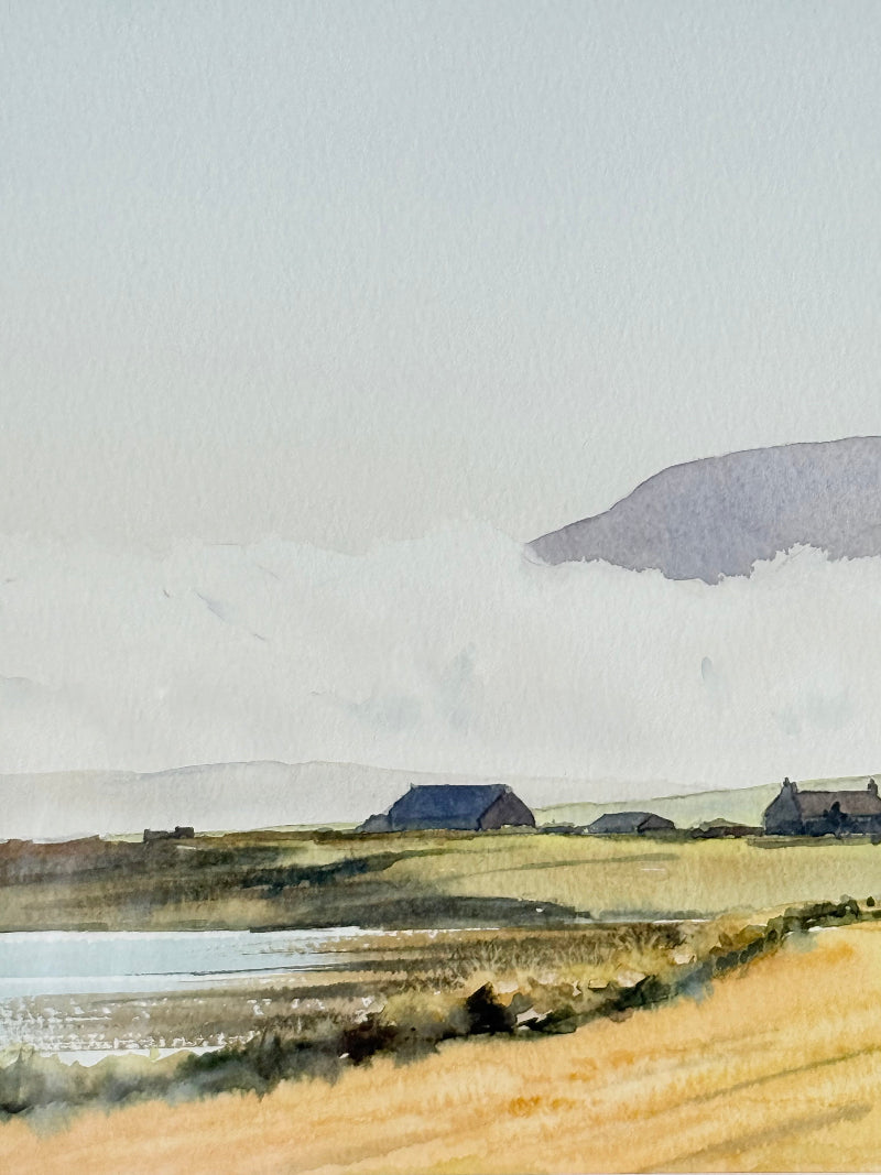 Framed Scottish watercolour coastal landscape by Martin W. M. Prentice in green frame with double mount, on white surface.