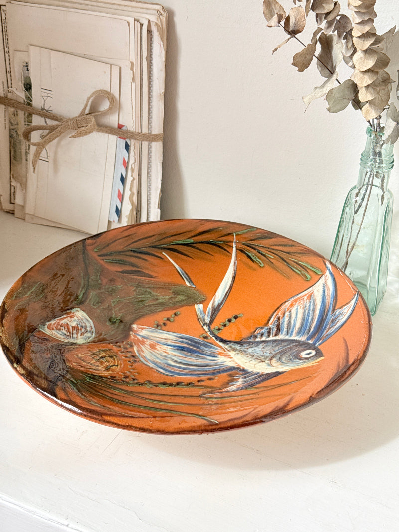 Mid century Puigdemont La Bisbal charger with hand painted fish in blue and white on orange glaze