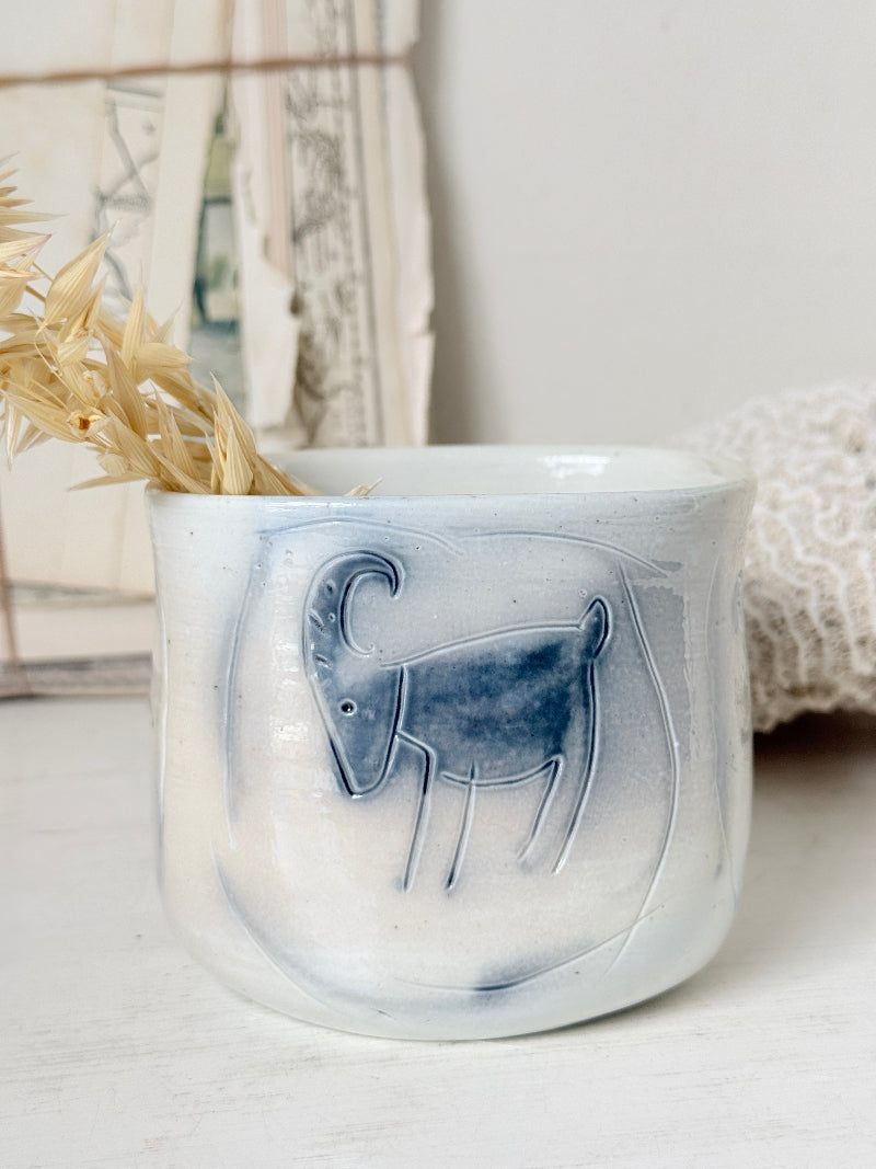 Hand painted ceramic pot with blue ram motif, pale grey off white glaze and handmade decorative form