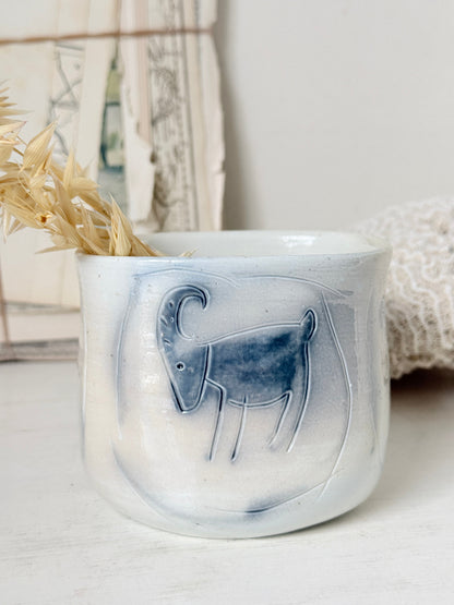 Hand painted ceramic pot with blue ram motif, pale grey off white glaze and handmade decorative form
