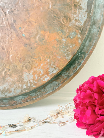 Vintage hand engraved copper tray with sunburst centre, decorative border and aged verdigris patina for wall or tabletop styling